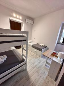 a room with two bunk beds and a table at Airport Al Volo B&B in Catania