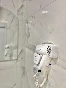 a hairdryer hanging on a wall in a bathroom at City center in Ulcinj