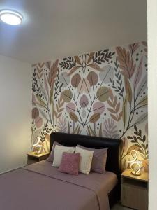 a bedroom with a bed with a floral wallpaper at City center in Ulcinj