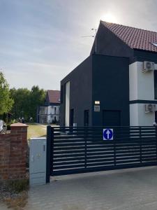a black fence in front of a house at Apartament Niechorze in Niechorze