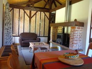 a living room with a table and a fireplace at Lo bonur es dens lo prat in Soustons