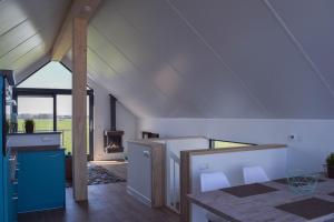 a kitchen and dining room with an attic at Roggebroek 29 in Stavoren