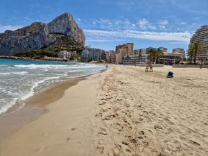 a sandy beach with a mountain in the background at Sea view and Ifach Calpe in Calpe