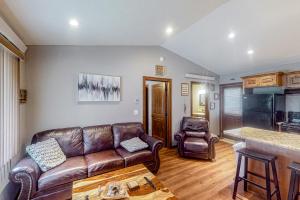 a living room with a leather couch and two chairs at Tumble Inn in Rapid City