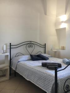 a bedroom with a bed with blue pillows on it at La Racioppola in Ostuni