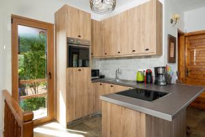 a kitchen with wooden cabinets and a counter top at Villa Beis in Porto Rafti