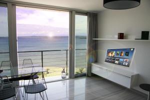 a living room with a view of the ocean at St.Barth Apartments in Šibenik