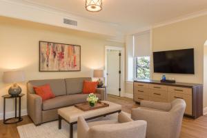 a living room with a couch and a tv at The Abbey Inn & Spa in Peekskill