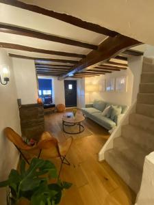 a living room with a couch and a table at 1750's cottage with open fire and beams in Upholland