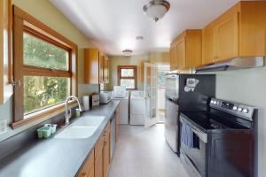 a kitchen with a sink and a stove top oven at Wallingford Heights in Seattle