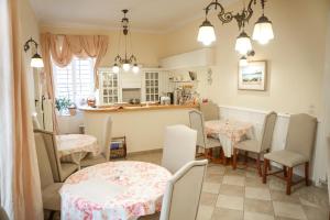 a kitchen and dining room with a table and chairs at Archontiko Eleni Hotel in Andros
