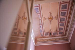 an ornate ceiling in a hallway of a building at Archontiko Eleni Hotel in Andros