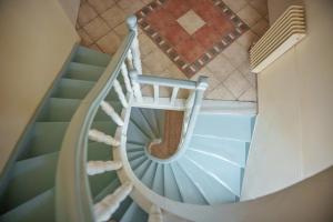 an overhead view of a spiral staircase in a house at Archontiko Eleni Hotel in Andros