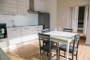 a kitchen with a table and chairs with wine glasses at Residence Il Poggio in Dorio