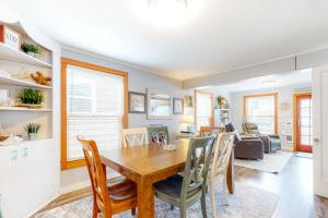 a dining room and living room with a table and chairs at Ocean Shells Cottage in Rockaway Beach
