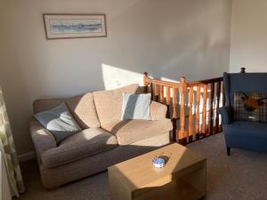 a living room with a couch and a chair at Edgemont Annexe Oban in Oban