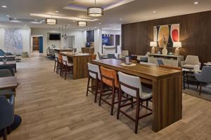 a restaurant with a large wooden table and chairs at Holiday Inn Express & Suites Charleston DWTN -Westedge, an IHG Hotel in Charleston