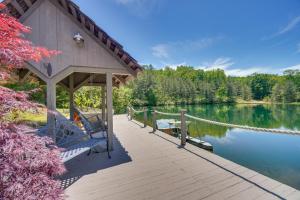 a wooden deck with chairs on the side of a lake at Charming Crossville Apt Less Than 10 Mi to Golf Courses! in Crossville