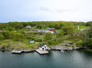 an aerial view of a house on an island in the water at Exclusive house with private boathouse in Nösund