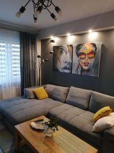a living room with a couch and a table at Apartament Euro 1 Bytom in Bytom