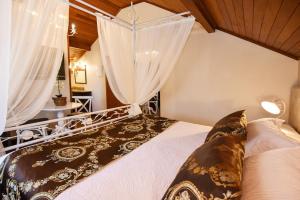 a bedroom with a large bed with curtains at Hotel Kehl Haus in Gramado