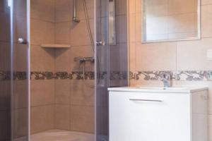 a bathroom with a shower and a sink at Domki wakacyjne Koral in Swarzewo