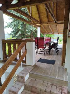 a patio with a table and chairs and a wooden ceiling at Klára Vendégház in Badacsonyörs