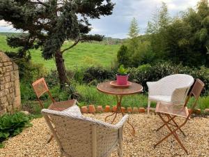 a table and two chairs and a table and a table and chairs at Studio indépendant /2 personnes in Le Bugue