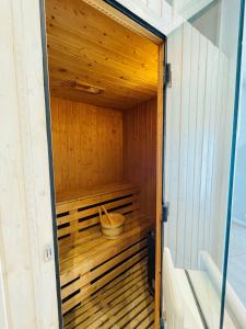 a wooden sauna with a bucket inside of it at Gîte "Au Fourneau" in Spa