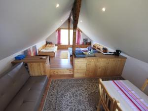 um quarto no sótão com uma cama e uma secretária em Farm Stay Ana em Višnja Gora