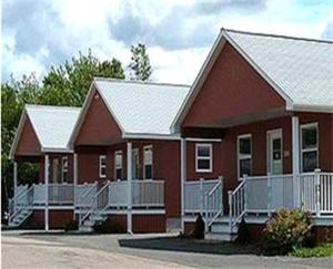 a couple of red houses with white at Clansman Motel in North Sydney