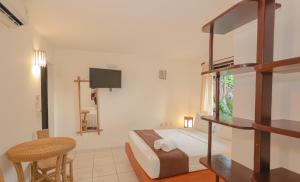a bedroom with a bunk bed and a desk at Pousada Saudosa Maloca in Arraial d'Ajuda