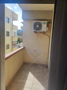 a balcony with a fan on the wall of a building at Bed and Breakfast Oasi in Reggio di Calabria