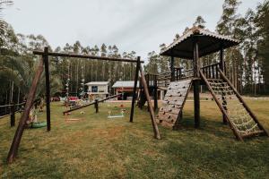 an outdoor playground with a slide and a play structure at RECANTO DA SERRA in Mauá da Serra
