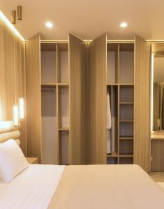 a bedroom with a bed and a closet at Amsterdam Hotel Aktobe in Aktobe