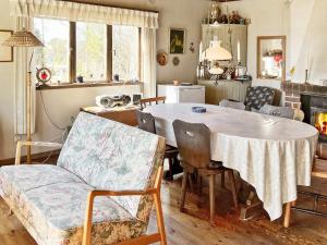 ein Wohnzimmer mit einem Tisch, Stühlen und einem Sofa in der Unterkunft Holiday home DALARÖ II in Dalarö