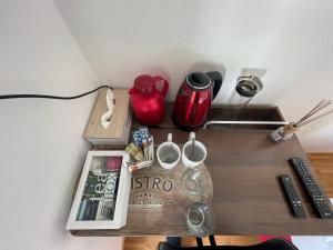 una mesa con un estante con un libro y un mando a distancia en Boutique Zimmer Privat 1-4 Personen en Frankfurt