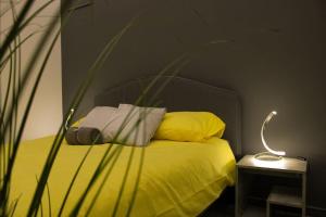 a bedroom with a yellow bed with a camera on it at High end 2 bedroom apartment in downtown in Budapest