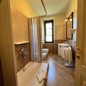 a bathroom with a tub and a toilet and a sink at Agriturismo Podere Cottimellino - B&B in Val d'Orcia in Montalcino