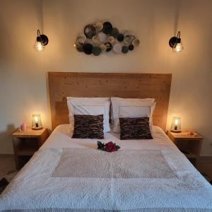 a bedroom with a bed with two night stands and two lights at Belle Vue de St Gervais in Saint-Gervais-les-Bains