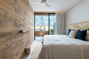 a bedroom with a wooden accent wall and a bed at 6 Guests - Amazing Views -Top Design in San José del Cabo