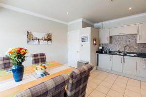 a kitchen and dining room with a table and chairs at Birkby Lodge Escape in Lytham St Annes