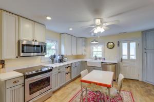 a kitchen with white cabinets and a table and a ceiling fan at Mtn Views and Epic Sunsets Private Weaverville Home in Weaverville