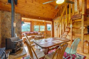 a dining room with a table and chairs and a stove at Secluded Mountain Cabin with Decks and Gazebo! in Brasstown