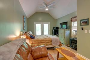 a bedroom with a bed and a couch at Secluded Mountain Cabin with Decks and Gazebo! in Brasstown