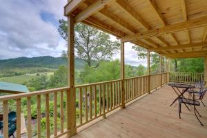 a wooden deck with a table and chairs on it at Secluded Mountain Cabin with Decks and Gazebo! in Brasstown
