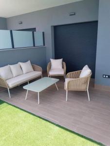 a living room with two chairs and a coffee table at Gran Apartment-Iconic Sea View in Gran Alacant