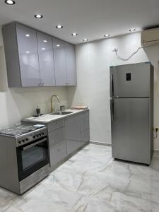a kitchen with a stainless steel refrigerator and sink at בית נופש בוטיק - Boutique holiday home in Bayit Wegan