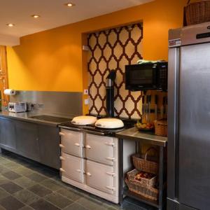 a kitchen with a counter with a microwave at Schoolhouse Ballater B&B in Ballater