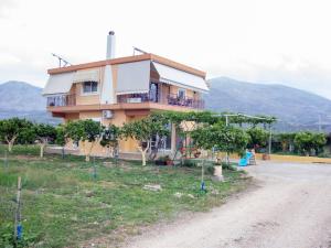 a house on a hill with a playground in front of it at Ktima Bavella Apartment Sophia 